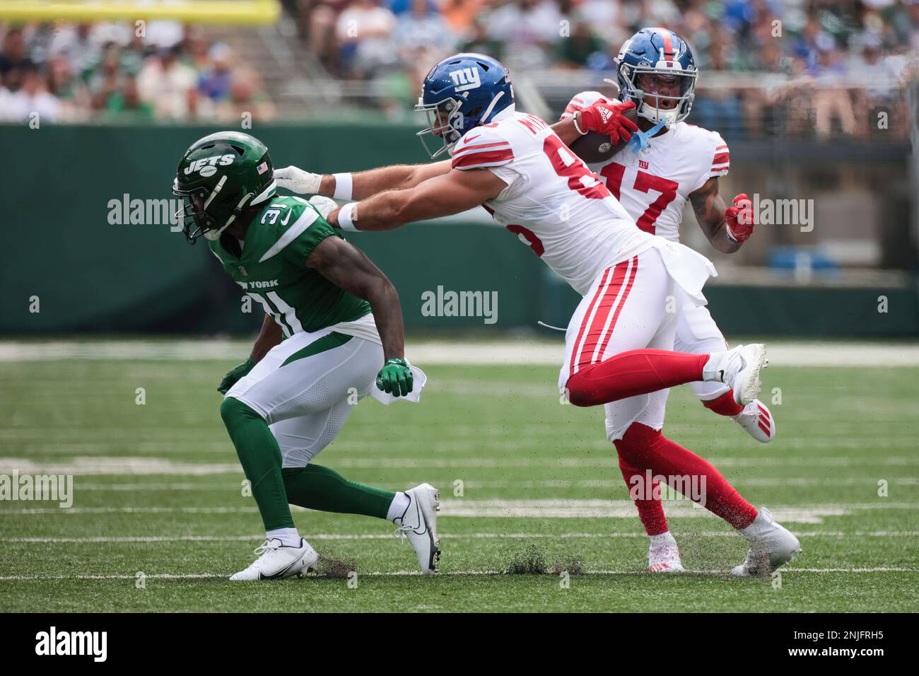 EAST RUTHERFORD, NJ - AUGUST 28: New York Giants wide receiver Wan'Dale  Robinson (17) gets a great block from New York Giants tight end Chris  Myarick (85) during the National Football League