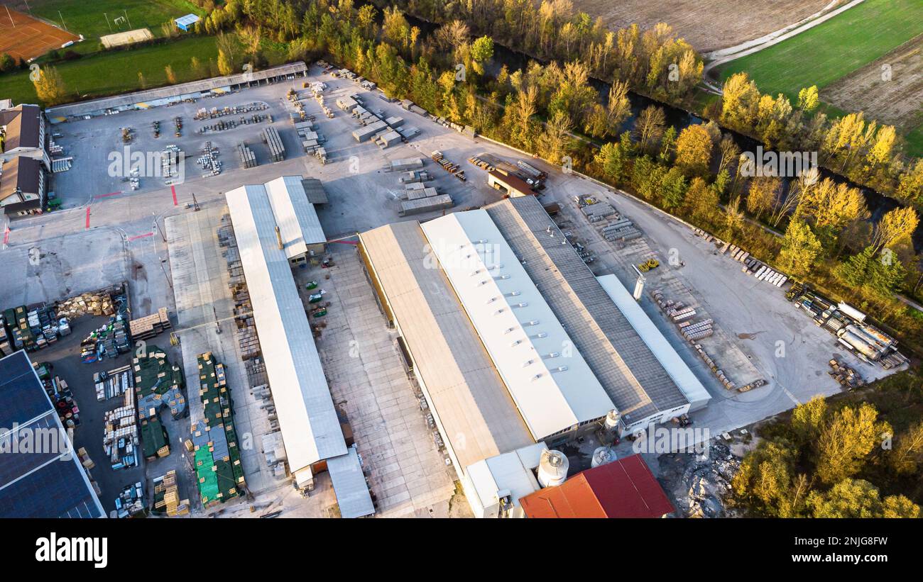 Concrete factory with cement trucks and heavy machinery. Drone aerial