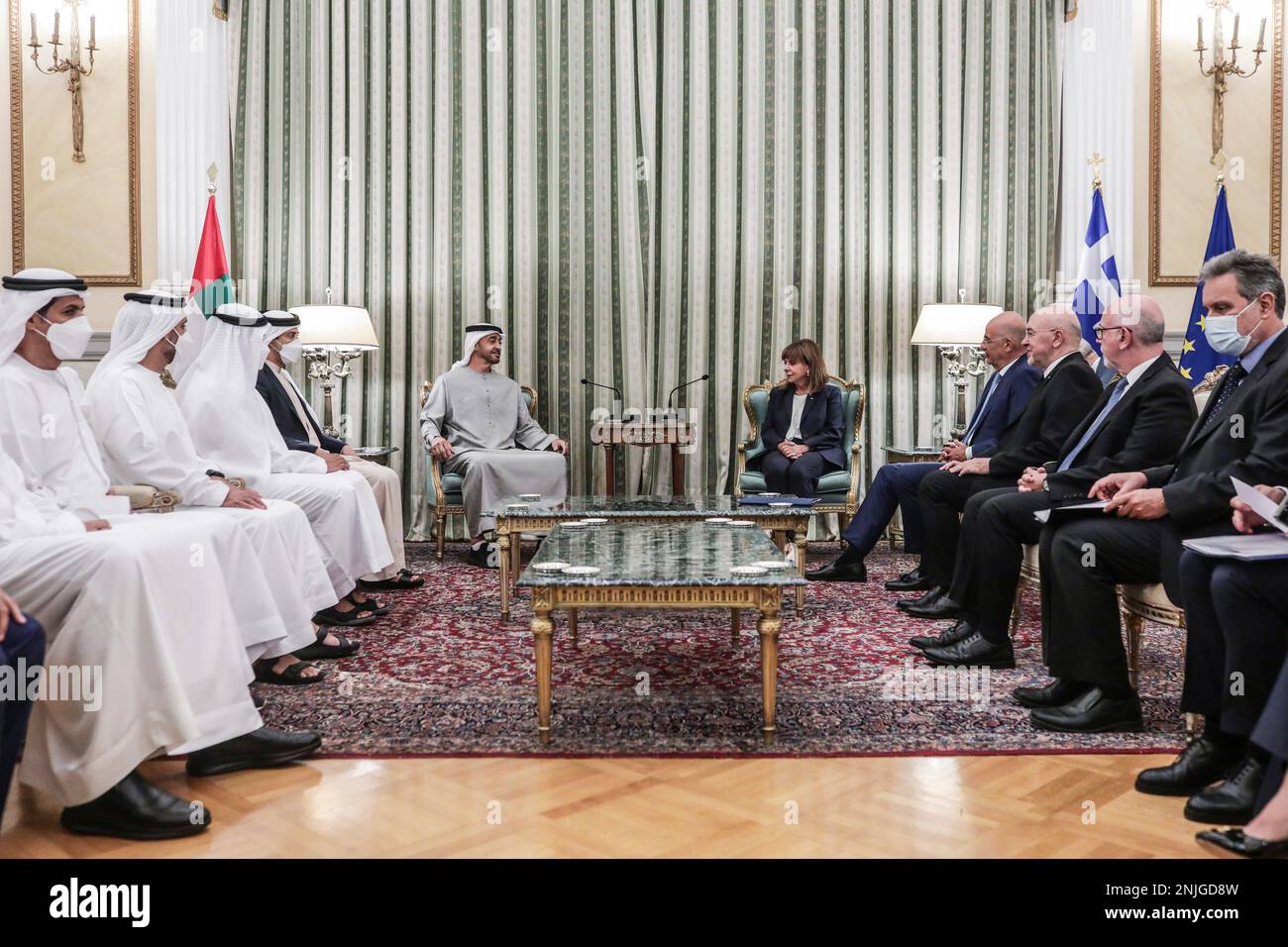 In this photo provided by the Greek President's office, Greece's President  Katerina Sakellaropoulou, right, joins a meeting with United Arab Emirates'  President Sheikh Mohammed Bin Zayed and other officials at the Presidential