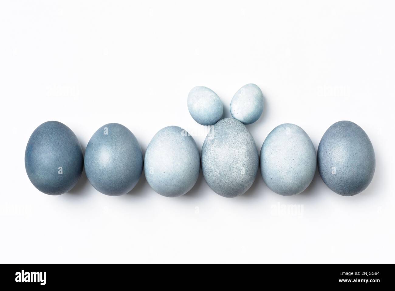 Easter eggs in row, one is standing out with bunny ears. Stock Photo