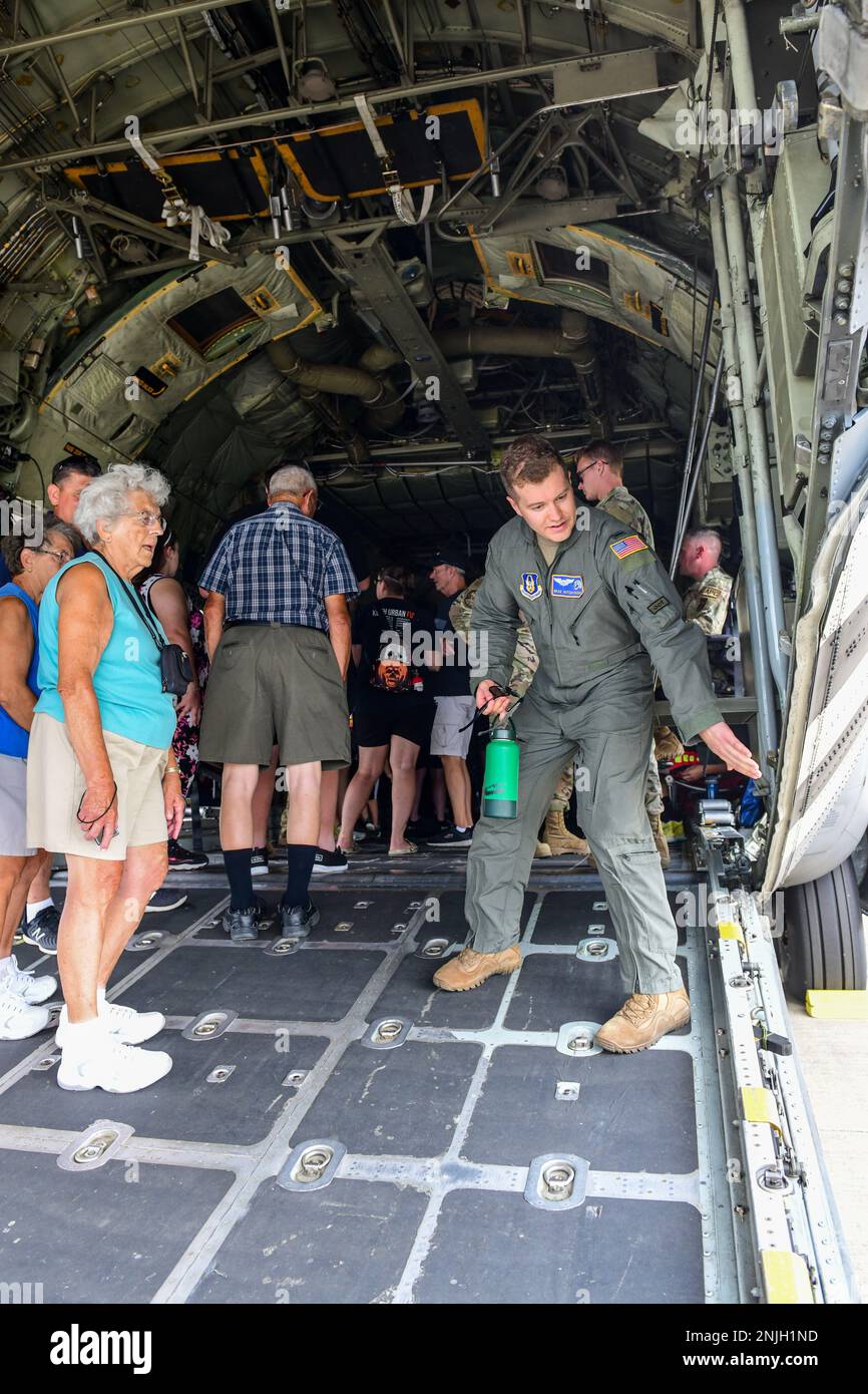 First Lt. Brad Hutchinson, a pilot assigned to the 757th Airlift Squadron, talks with event guests inside a C-130H Hercules, Aug. 7, 2022, at the Wings and Wheels Fly-In and Car Show at Youngstown-Warren Regional Airport, Ohio. The event had more than 100 different aircraft on display with some available for event guests to tour inside. Stock Photo