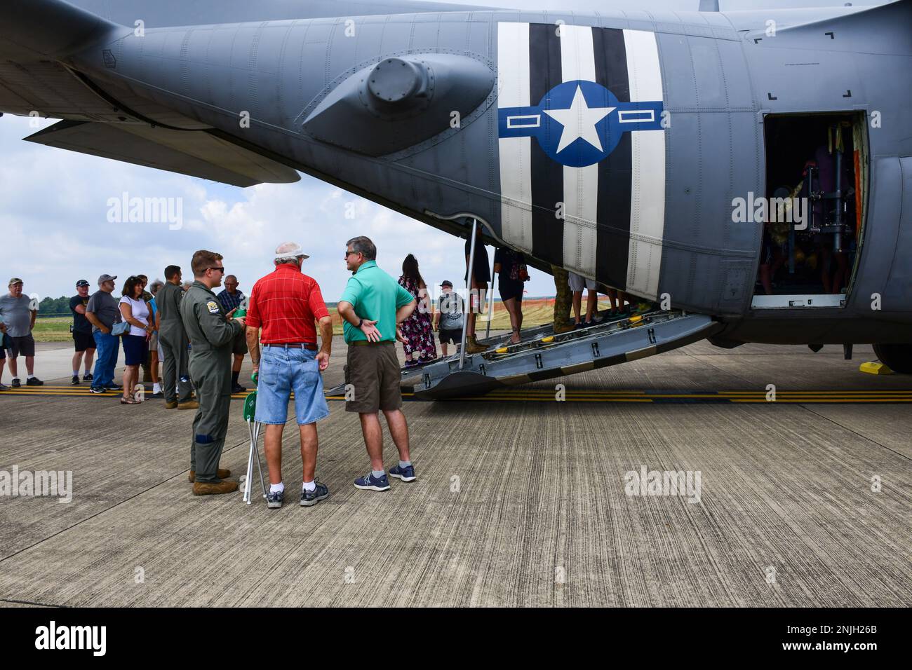 Reserve Citizen Airmen of the 910th Airlift Wing talk with event guests near a C-130 Hercules, Aug. 7, 2022 at the Wings and Wheels Fly-In and Car Show at Youngstown-Warren Regional Airport, Ohio. The event had more than 100 different aircraft on display with some available for event guests to tour inside. Stock Photo