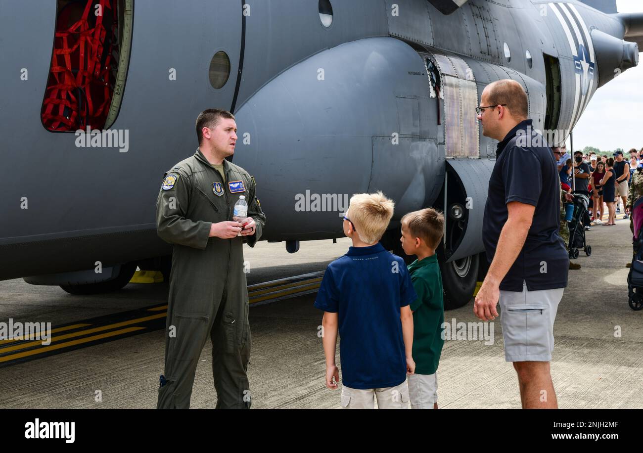 First Lt. Cole Buttermore, a pilot assigned to the 757th Airlift Squadron, talks with event guests near a C-130H Hercules, Aug. 7, 2022, at the Wings and Wheels Fly-In and Car Show at Youngstown-Warren Regional Airport, Ohio. The event had more than 100 different aircraft on display with some available for event guests to tour inside. Stock Photo