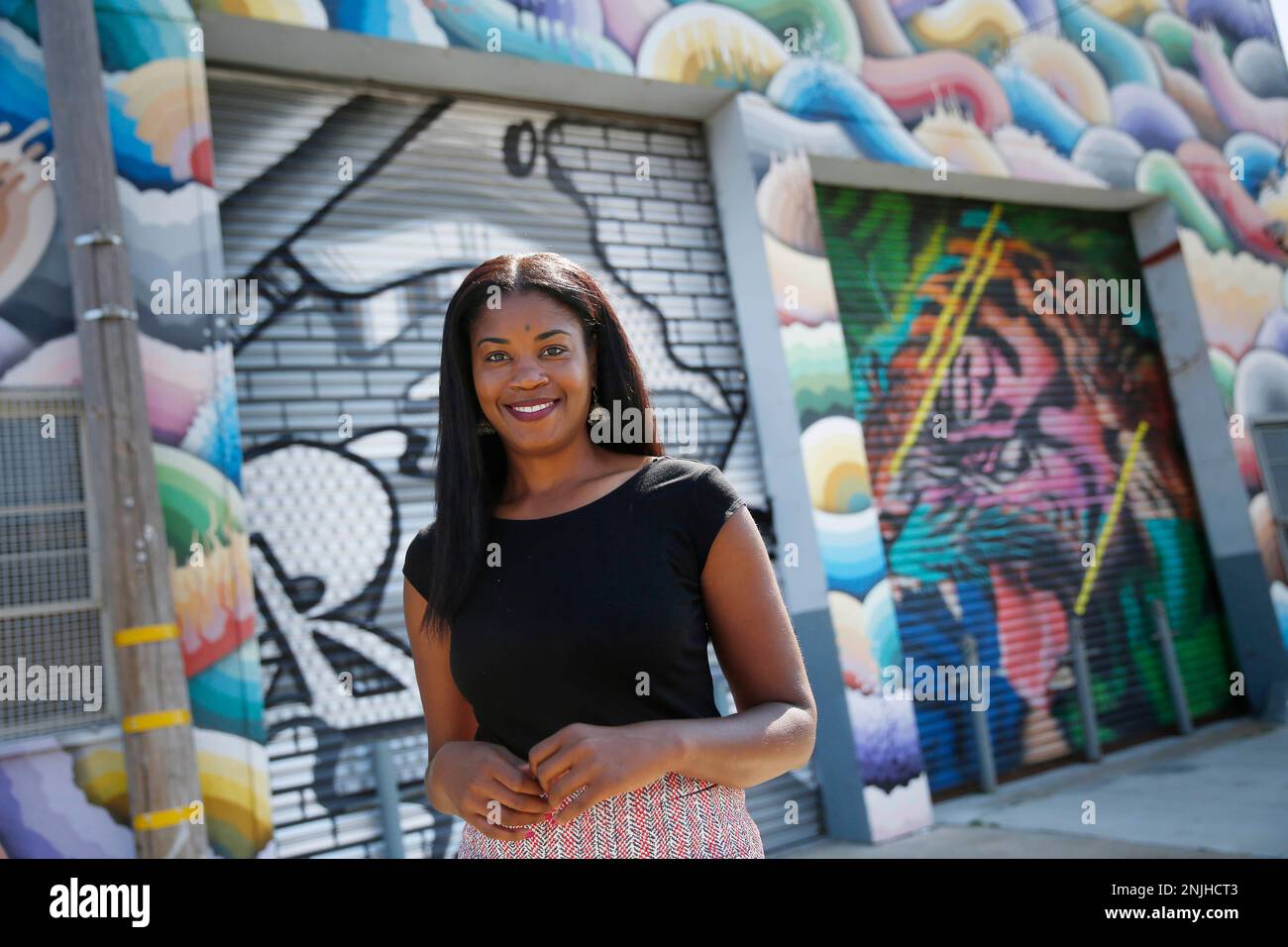 Tyra Fennell, Imprint City founder and CEO, stands for a portrait on Egbert Street in front of