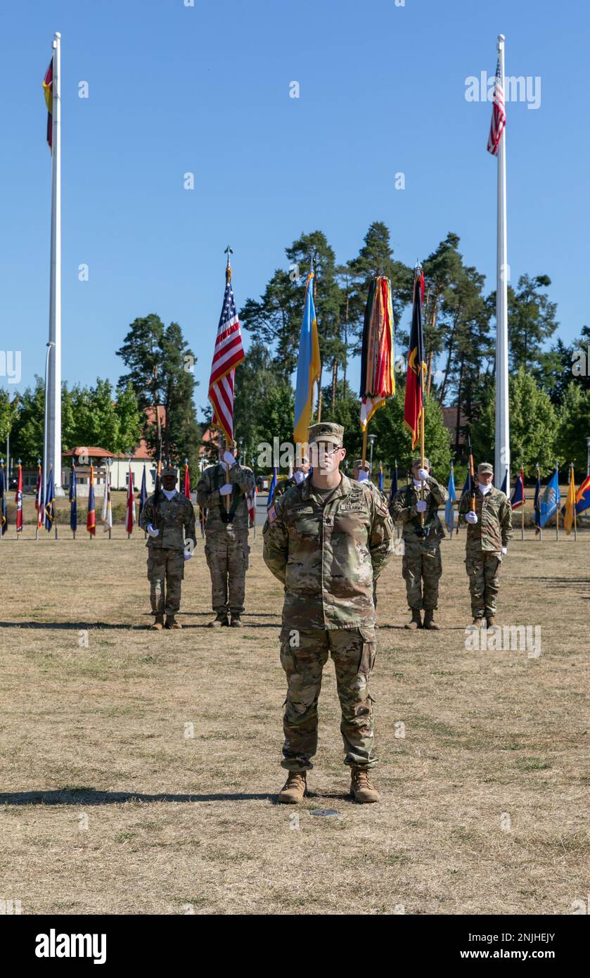 U.S. Army Lt. Col. Todd Hopkins, chief of staff of Task Force Gator, 53rd Infantry Brigade Combat Team, Florida Army National Guard stand in front of a color guard during the Joint Multinational Training Group-Ukraine Transfer of Authority ceremony in Grafenwoehr, Germany, August 8, 2022. Task Force Gator deployed to Ukraine in November 2021 and moved the JMTG-U mission to Grafenwoehr in April 2022 following Russia’s invasion of Ukraine. Stock Photo
