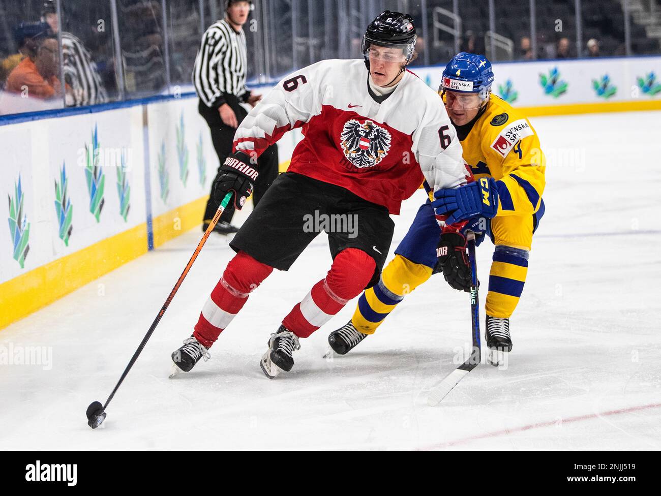 Sweden's Emil Andrae (4) and Austria's Luca Auer (6) battle for the puck during third-period IIHF World Junior Hockey Championship action in Edmonton, Alberta, Friday, Aug. 12, 2022. (Jason Franson/The Canadian Press via AP) Stock Photo