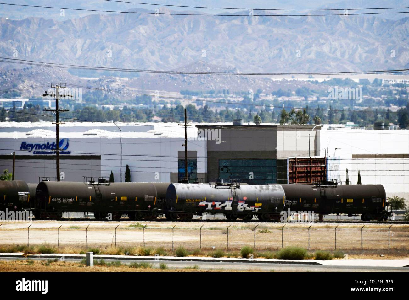 A rail car that officials say is leaking a toxic substance sits on the