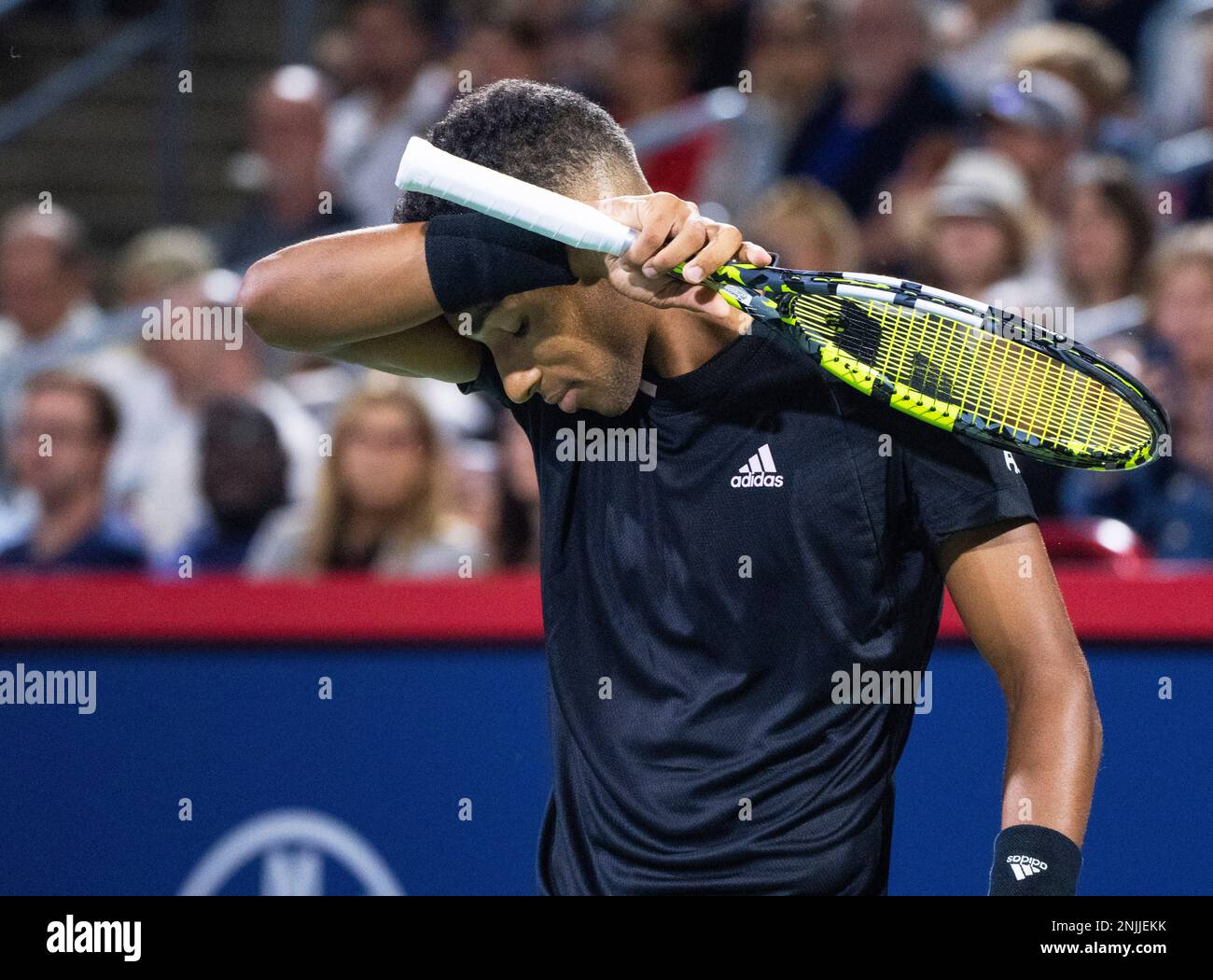 Canada's Felix Auger-Aliassime wipes his face during his match against  Yoshihito Nishioka, of Japan, during the National Bank Open tennis  tournament Wednesday, Aug. 10, 2022, in Montreal. (Paul Chiasson/The  Canadian Press via