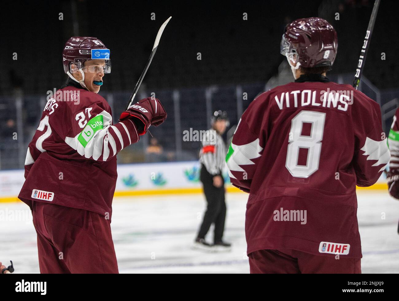 Latvias Klavs Veinbergs (27) and Raimonds Vitolins (8) celebrate a goal against Finland during the third period of an IIHF world junior hockey championships game Tuesday, Aug