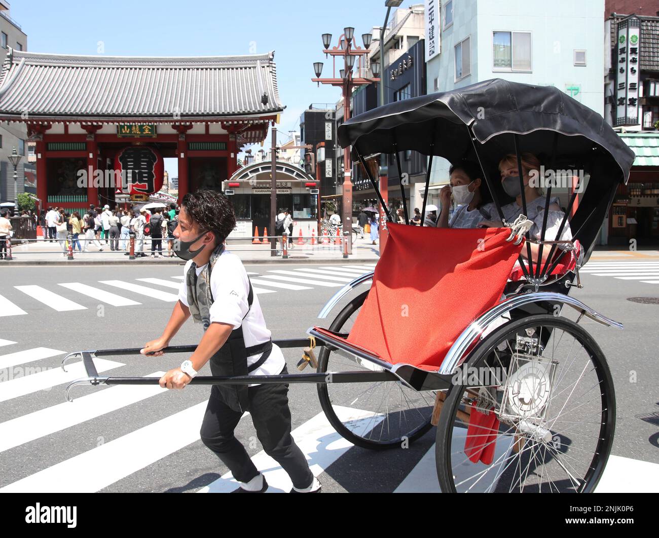 People ride rickshaw during hot day at Asakusa district in Taito Ward