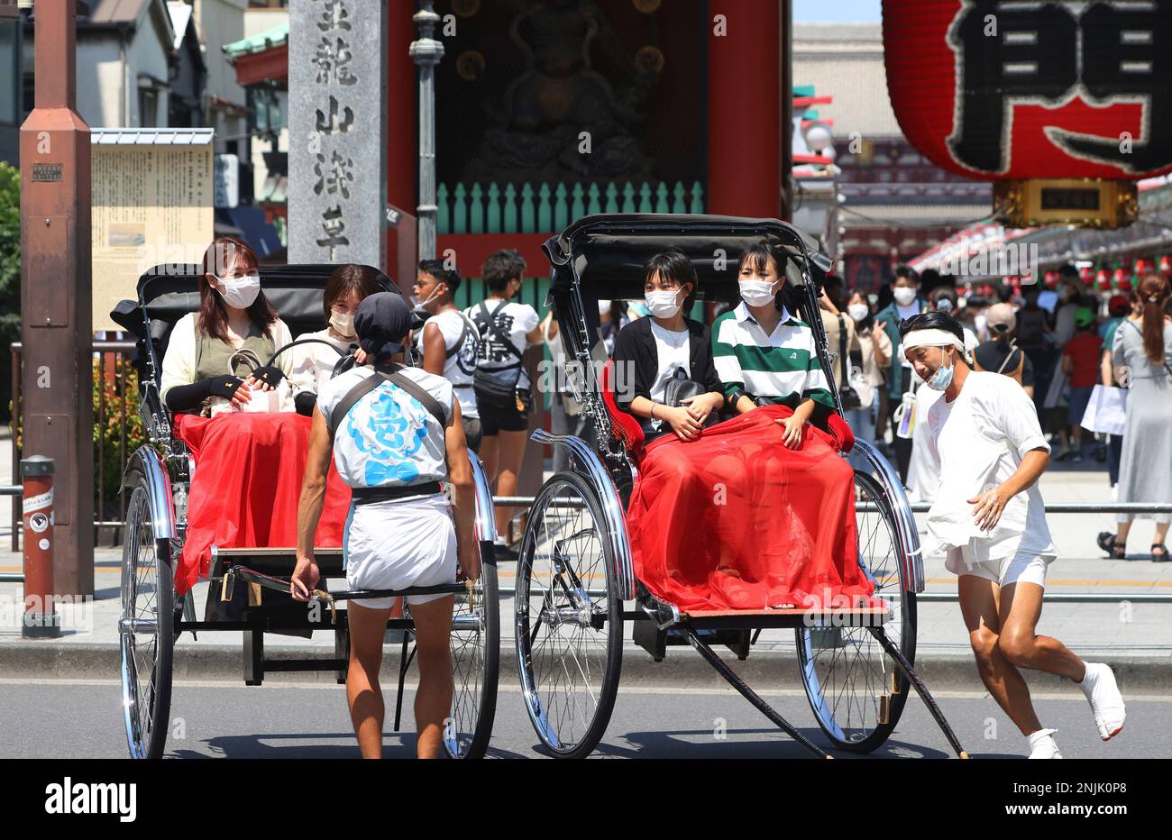 People ride rickshaw during hot day at Asakusa district in Taito Ward