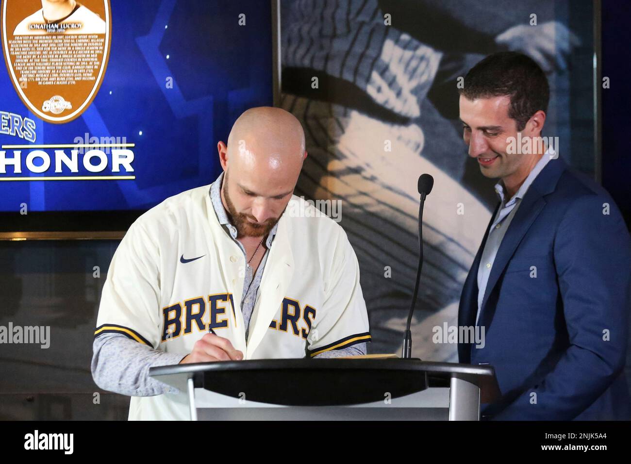 MILWAUKEE, WI - AUGUST 06: Milwaukee Brewer catcher Jonathan Lucroy signs  his retirement papers prior to a game between the Milwaukee Brewers and the  Cincinnati Reds at American Family Field on August
