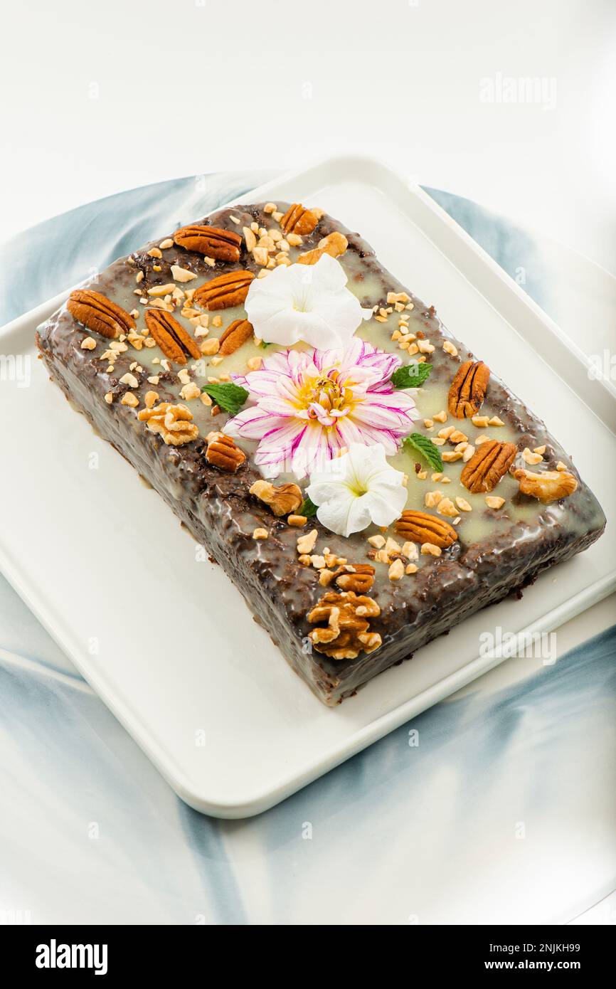 Freshly baked chocolate loaf cake with a variety of crushed nuts Stock ...