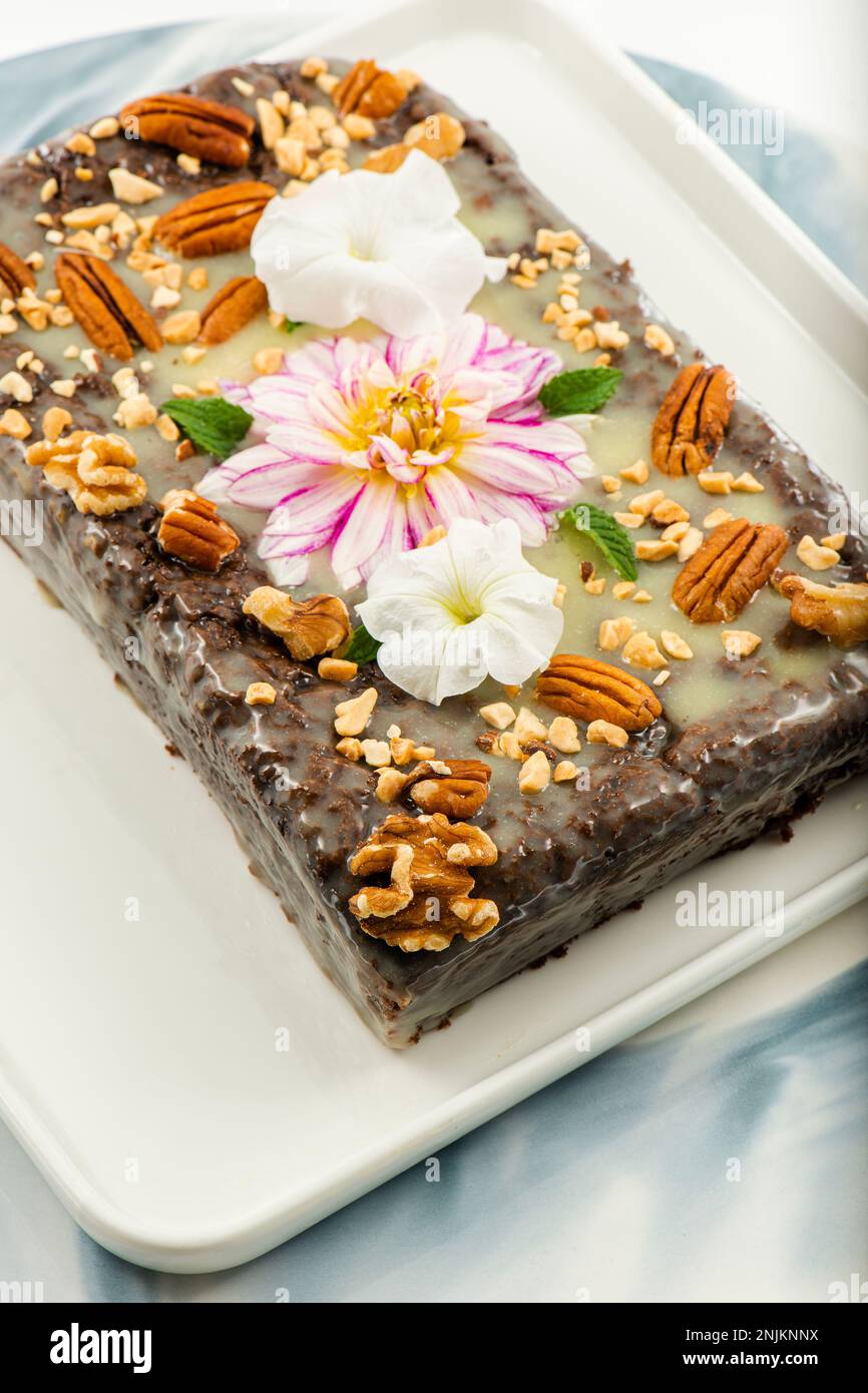 Freshly baked chocolate loaf cake with a variety of crushed nuts Stock ...