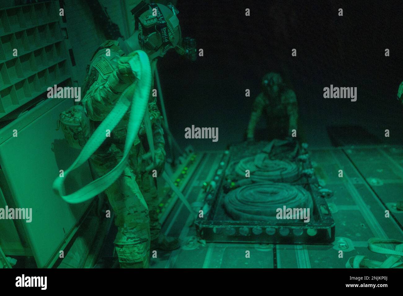 U.S. Air Force Senior Airman James Wheeler (left) and Airman 1st Class Emilio Saldana (right), forward area refueling point (FARP) specialists assigned to the 26th Expeditionary Rescue Squadron, load refueling equipment onto an HC-130J Combat King II aircraft within the U.S. Central Command area of responsibility, Feb. 16, 2023. FARP specialists provide a unique refueling capability, extending the reach of a variety of aircraft in austere locations across the CENTCOM AOR. (U.S. Air force photo by Staff Sgt. Kirby Turbak) Stock Photo