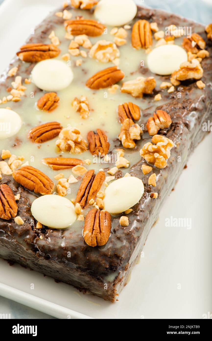 Freshly baked chocolate loaf cake with a variety of crushed nuts Stock ...