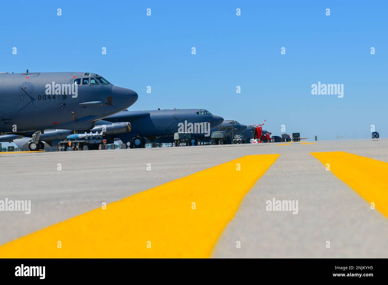Multiple B52H Stratofortresses sit parked at the flight line on Minot