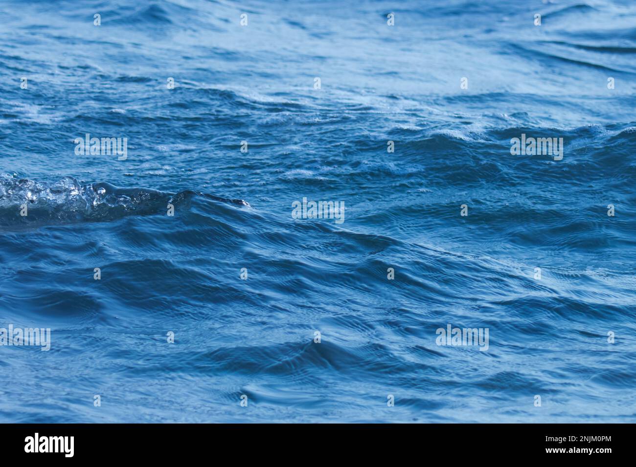 Blue ocean wave splashing on the beach. Sea wave Stock Photo - Alamy