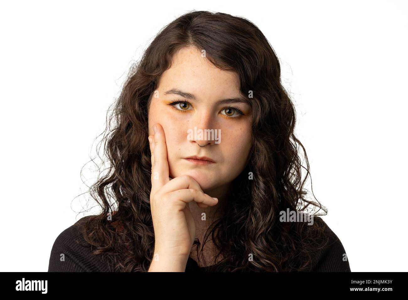 Beautiful woman deep in thought on white background Stock Photo - Alamy