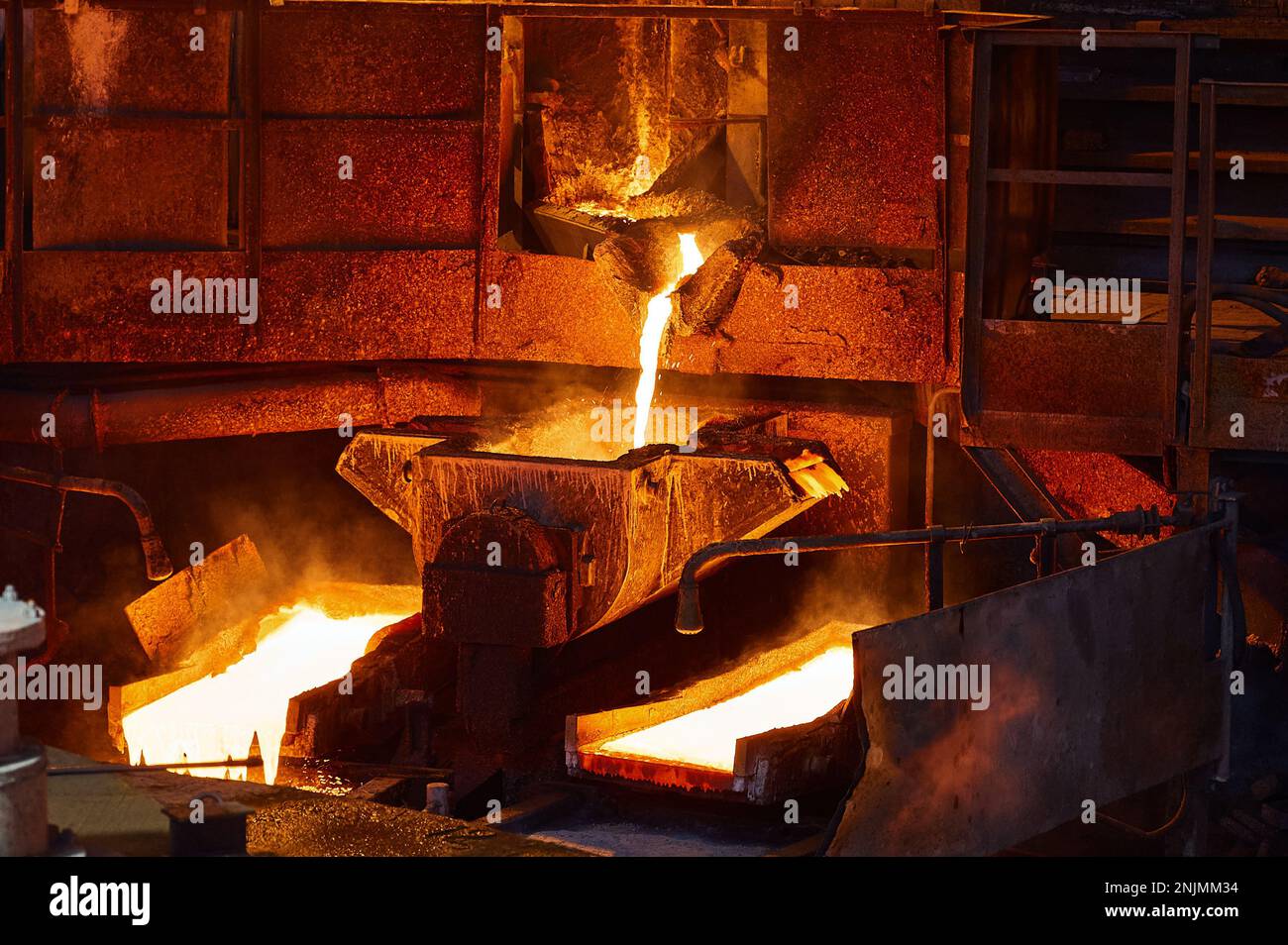 Pouring molten copper for anodes into form on casting wheel Stock Photo ...