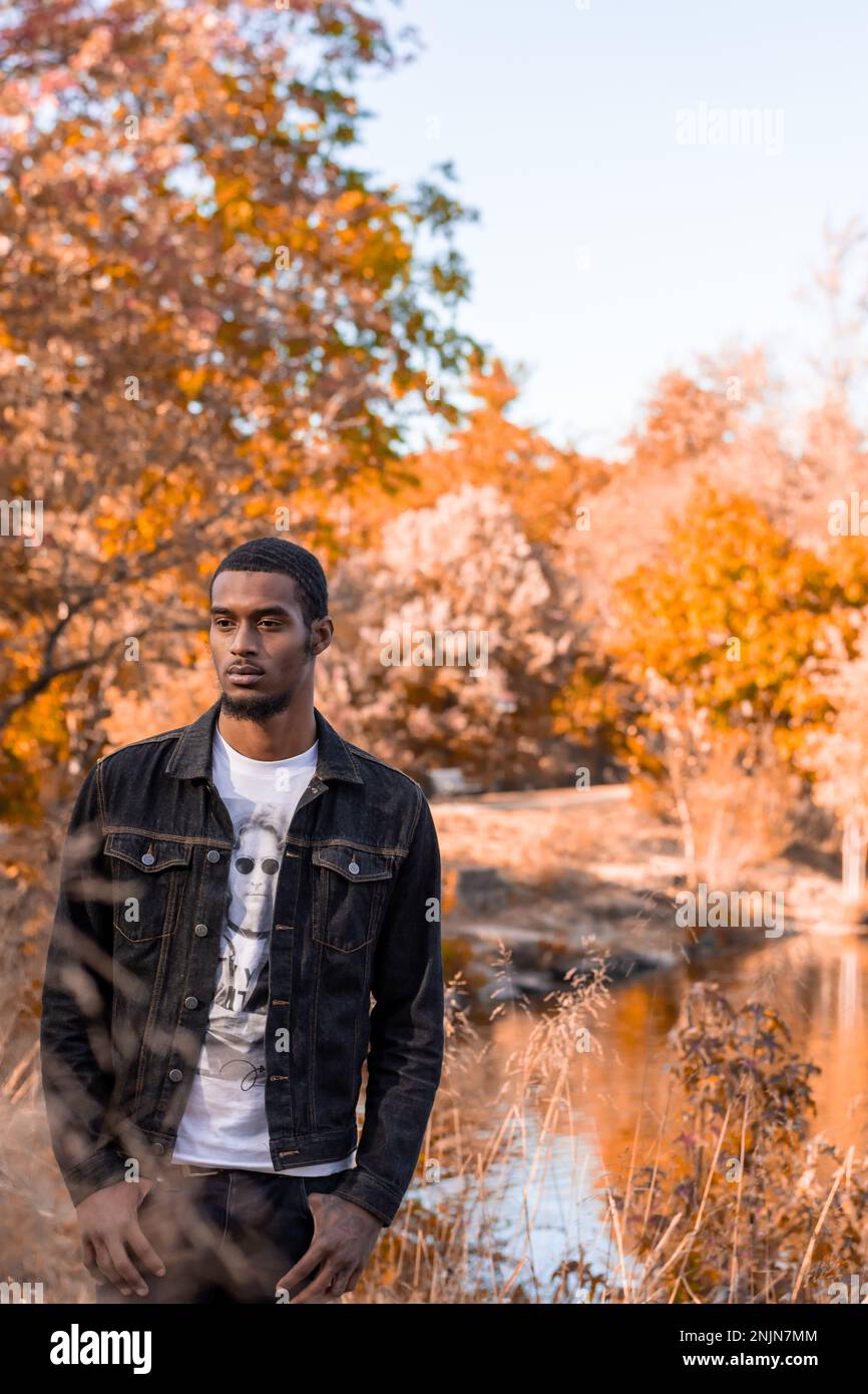 Young Afro latino man during Autumn at the park Stock Photo