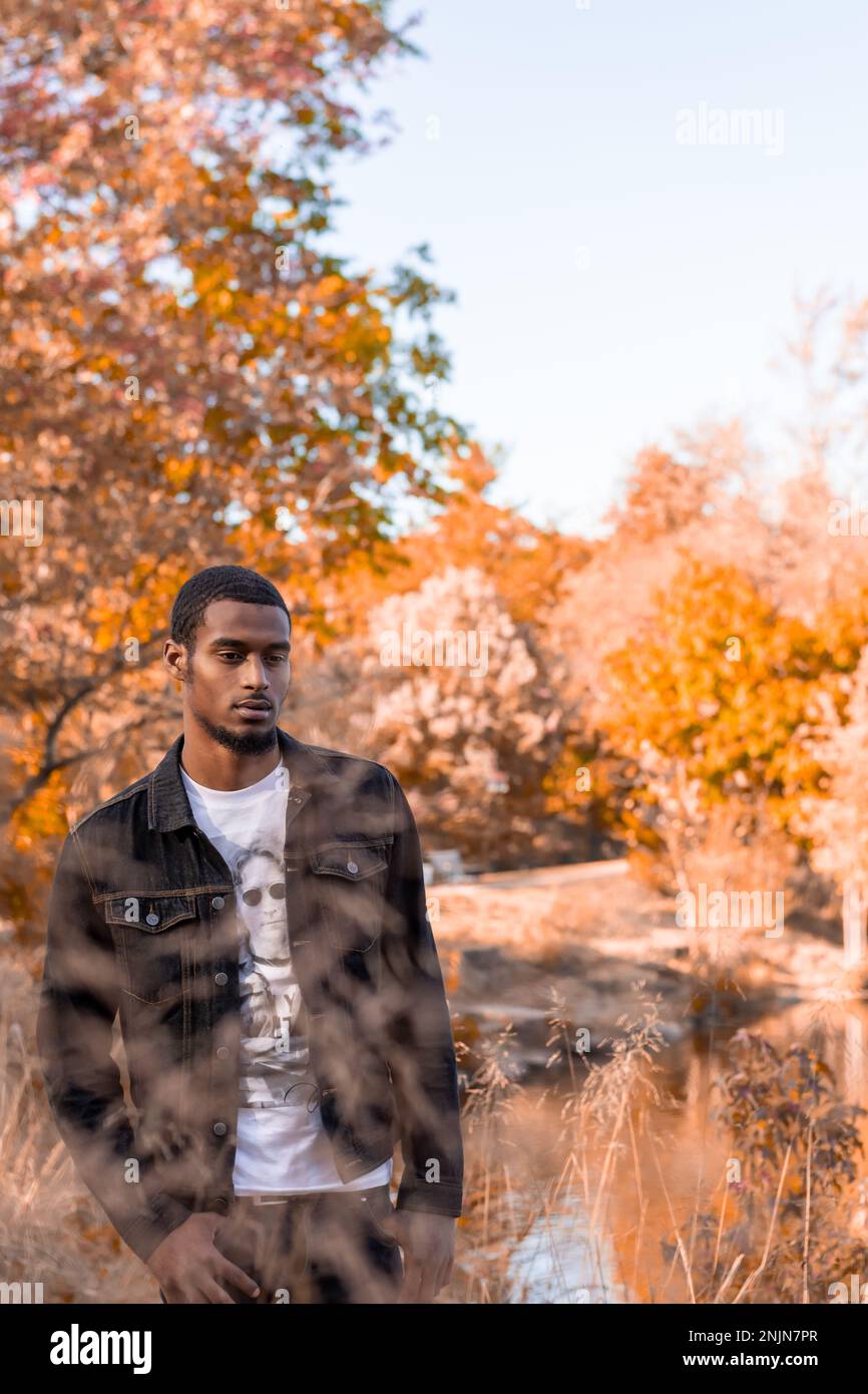 Young Afro latino man during Autumn at the park Stock Photo