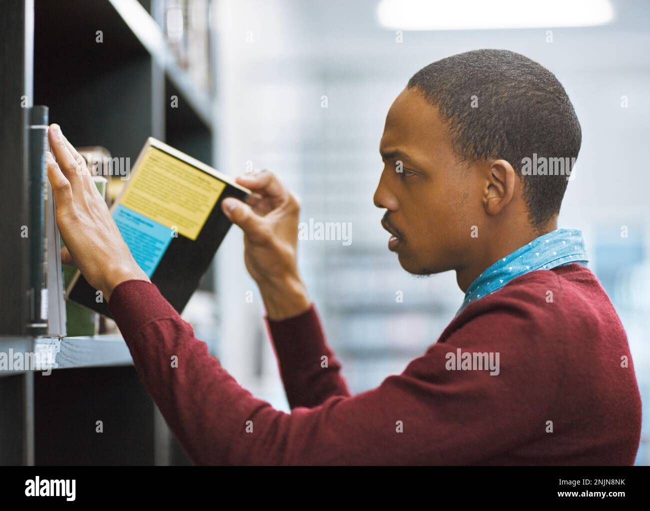 What book shall I read today. a determined looking young man taking a