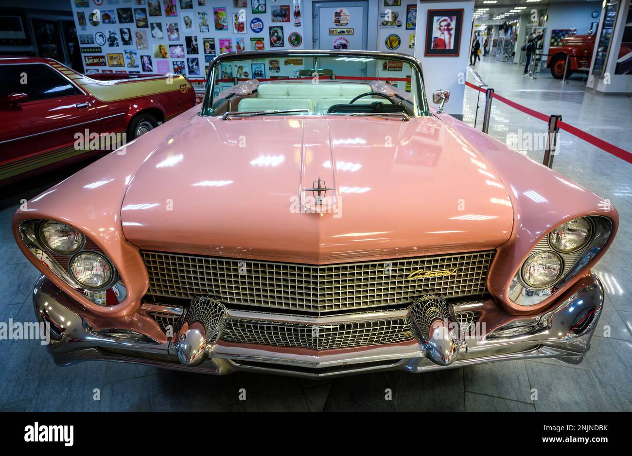 Front view of a large pink American retro car in the Automobile Museum