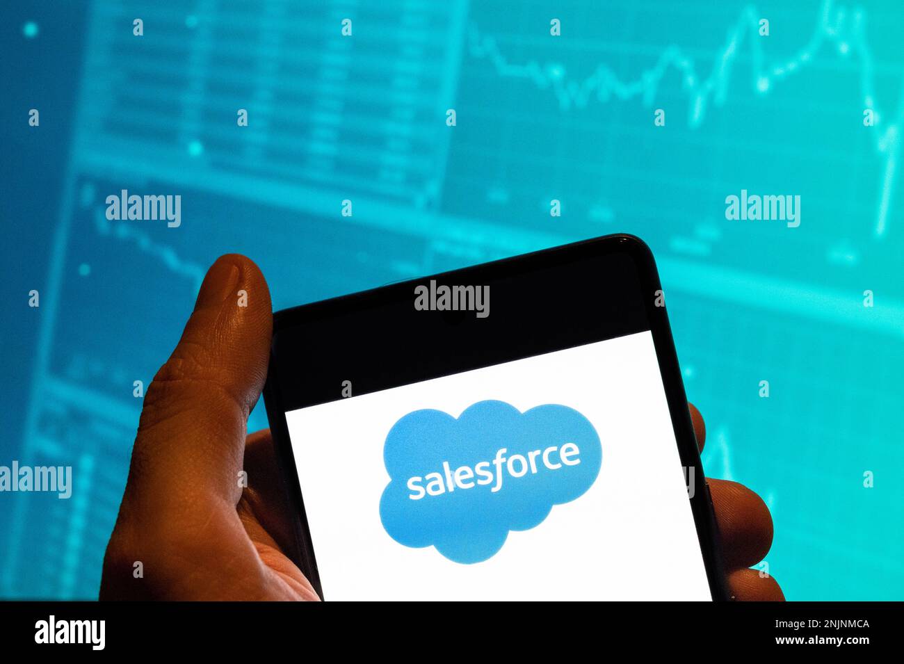 China. 15th Feb, 2023. In this photo illustration, the American cloud-based software company Salesforce logo is seen displayed on a smartphone with an economic stock exchange index graph in the background. (Credit Image: © Budrul Chukrut/SOPA Images via ZUMA Press Wire) EDITORIAL USAGE ONLY! Not for Commercial USAGE! Stock Photo