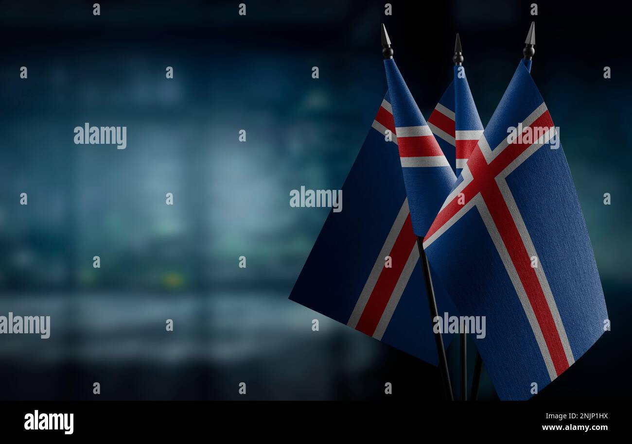 Small flags of the Iceland on an abstract blurry background Stock Photo ...