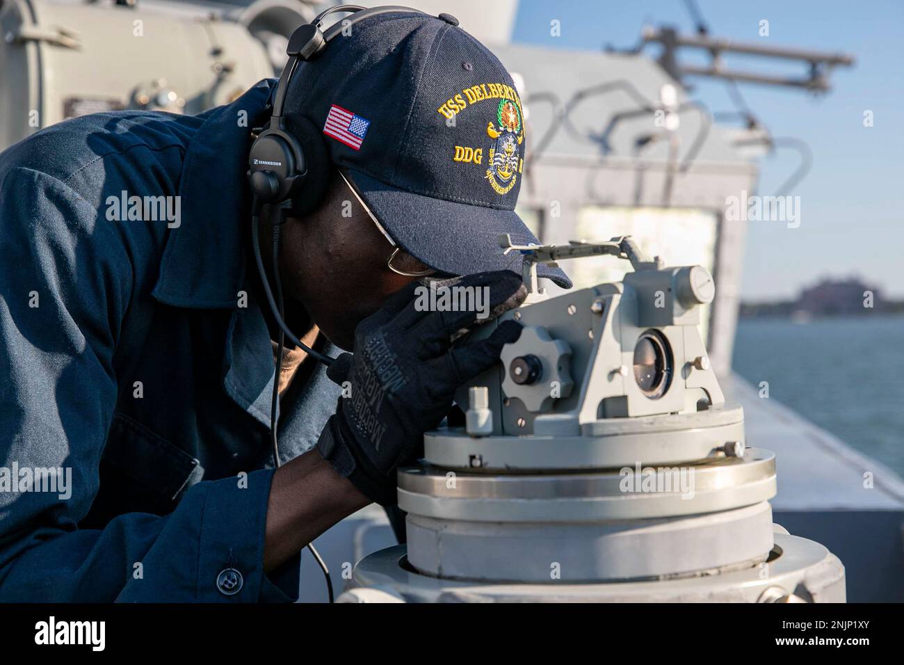 220809-N-UL352-1064 ATLANTIC OCEAN (Aug. 9, 2022) Quartermaster Seaman Kendal Norwood, assigned to the Arleigh Burke-class guided-missile destroyer USS Delbert D. Black (DDG 119), uses a telescopic alidade as the ship departs Naval Station Norfolk, Aug. 9, 2022. Delbert D. Black is part of the George H.W. Bush Carrier Strike Group, an integrated combat weapons system that delivers superior combat capability to deter, and if necessary, defeat America’s adversaries in support of national security. Stock Photo