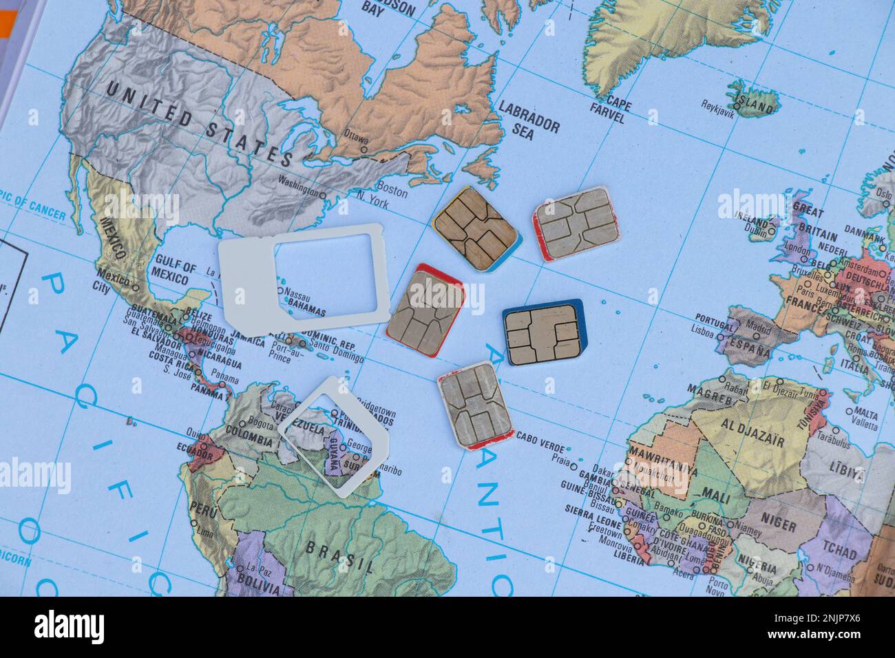 several sim cards are on a geographic map Stock Photo Alamy