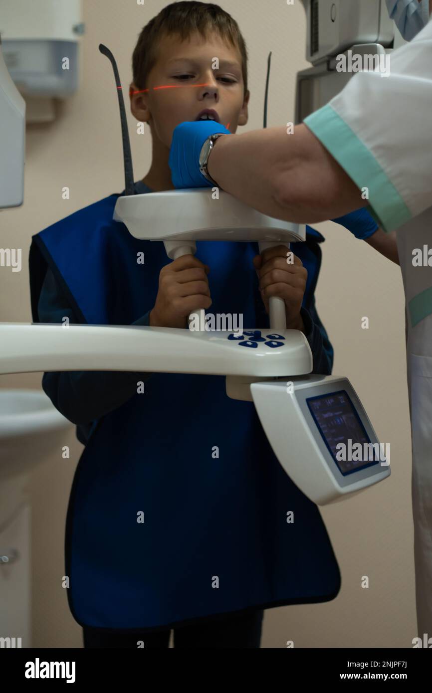 Jaw computed tomography, check up teeth in dental clinic. Boy in vest