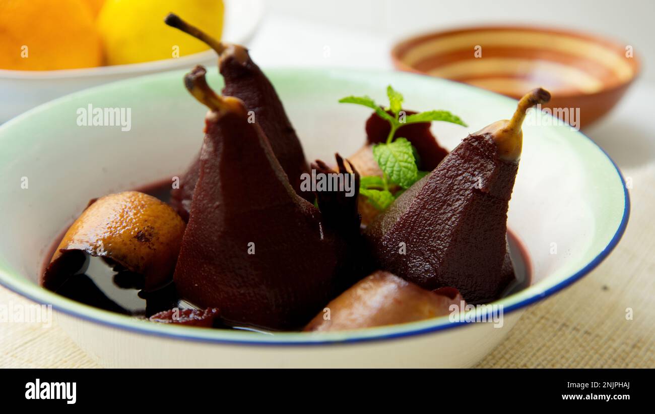 Pears cooked in red wine with orange. Stock Photo