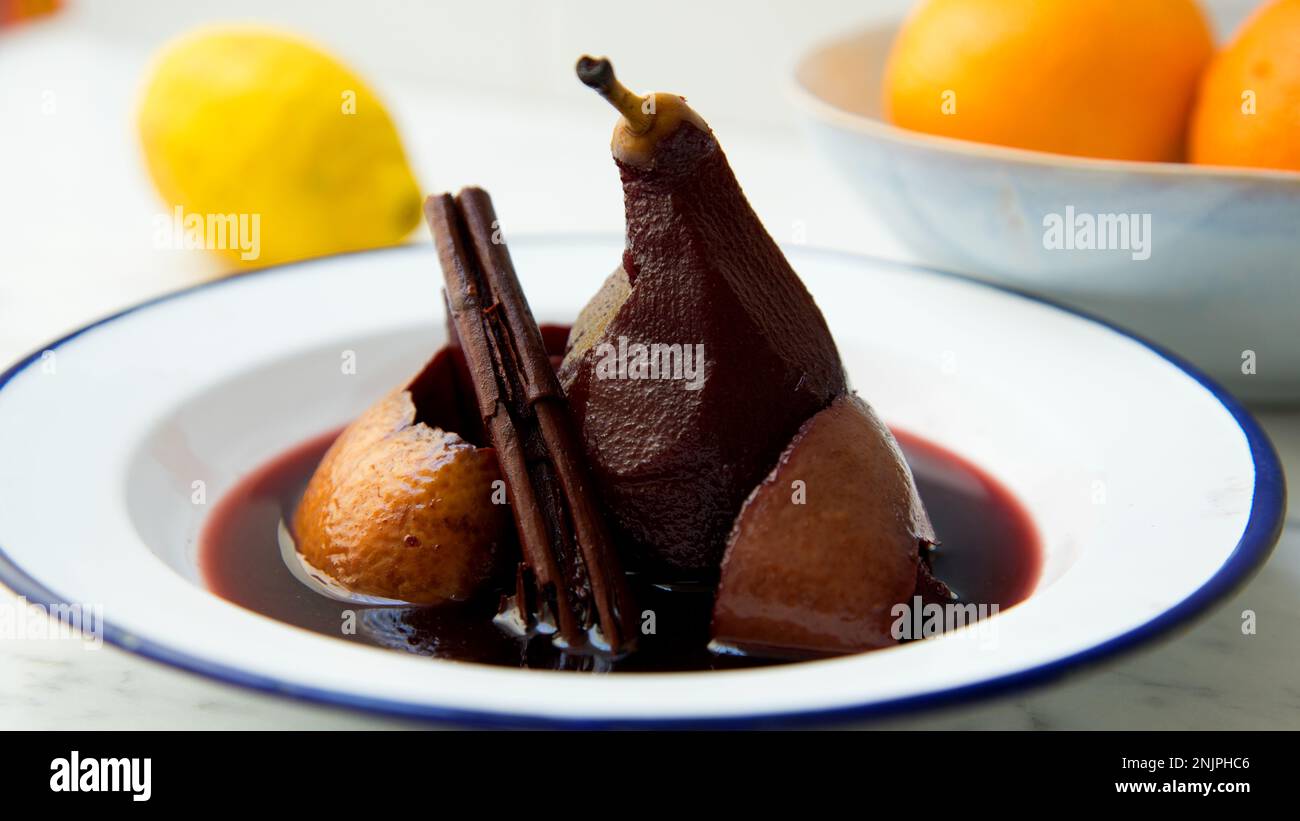 Pears cooked in red wine with orange Stock Photo Alamy