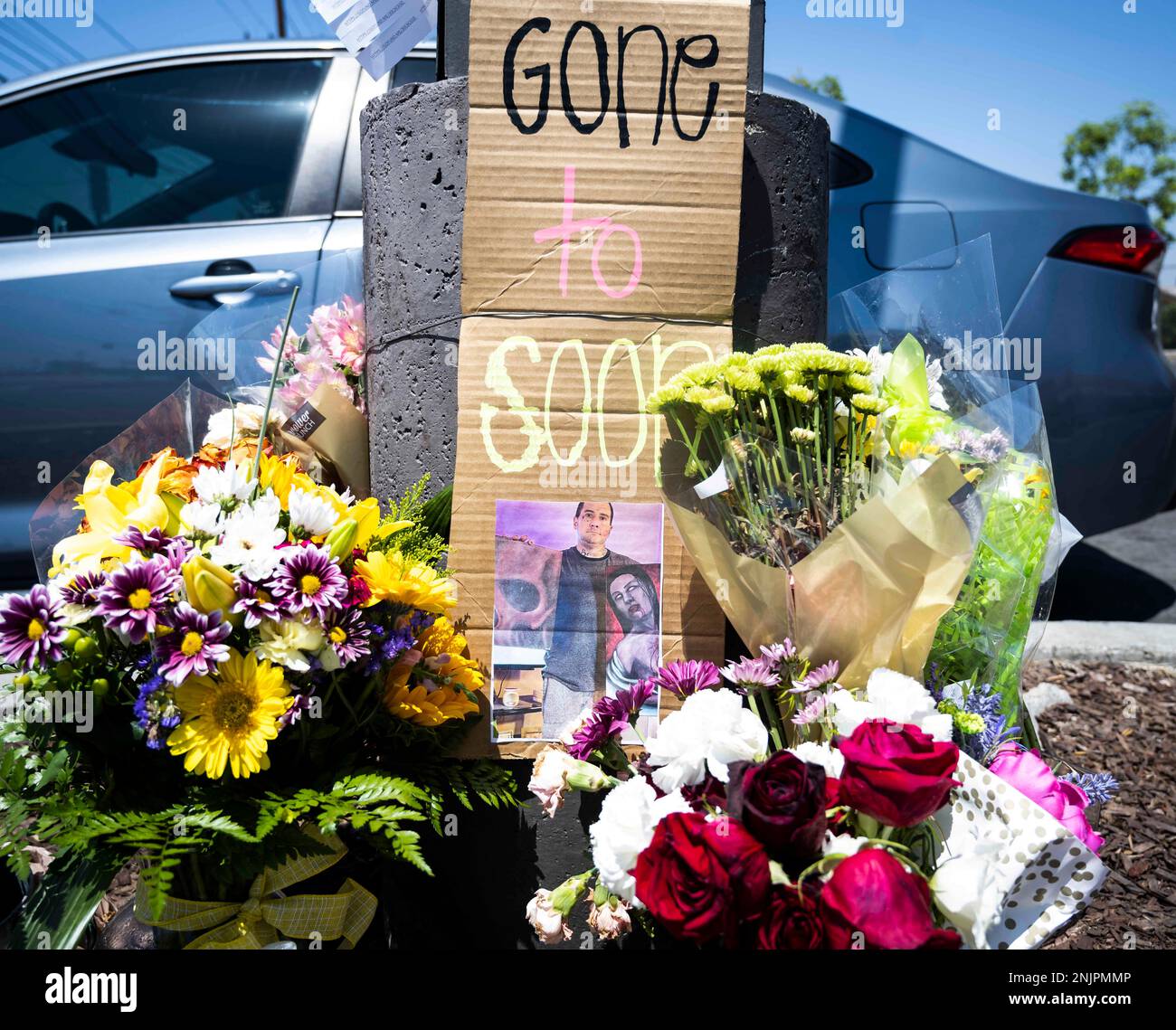 FILE - Flowers, candles and cards have been left at the parking lot of the 7 -Eleven store on W. Lambert Road in Brea, Calif., Thursday, July 14, 2022.  Authorities said Friday, July
