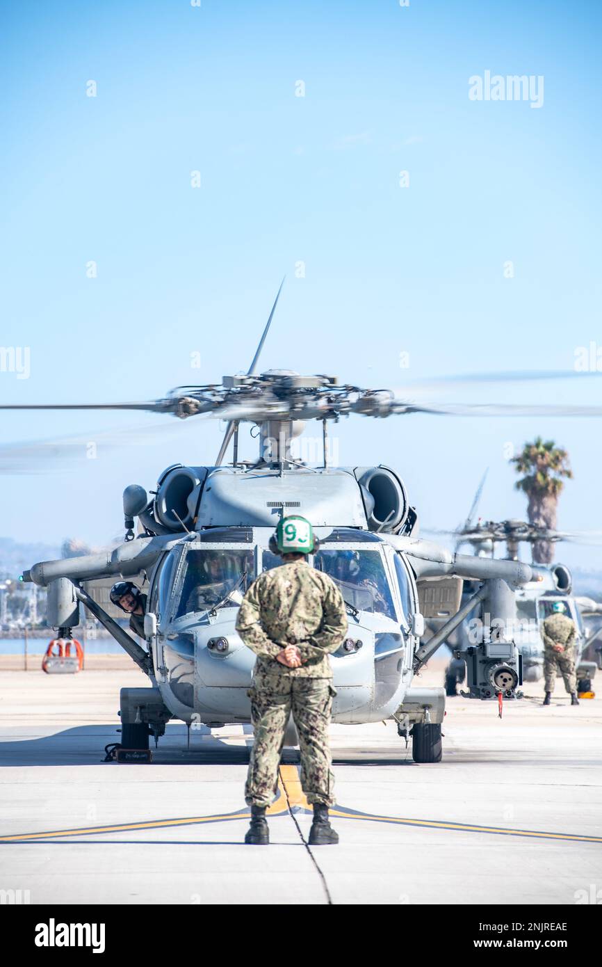 220805-N-EV253-1172 SAN DIEGO (Aug. 5, 2021) – An MH-60S Seahawk helicopters assigned to the 'Chargers' of Helicopter Sea Combat Squadron (HSC) 14, taxis on the flight line during a homecoming celebration. HSC-14, as part of Carrier Air Wing (CVW) 9, embarked aboard USS Abraham Lincoln (CVN 72) and returned to Naval Air Station North Island, Aug. 10, 2022, following a seven-month deployment to U.S. 3rd Fleet and 7th Fleet areas of operations. CVW-9 deployed with a combination of fourth and fifth-generation platforms that predominantly represent the “Airwing of the Future,” executing more than Stock Photo