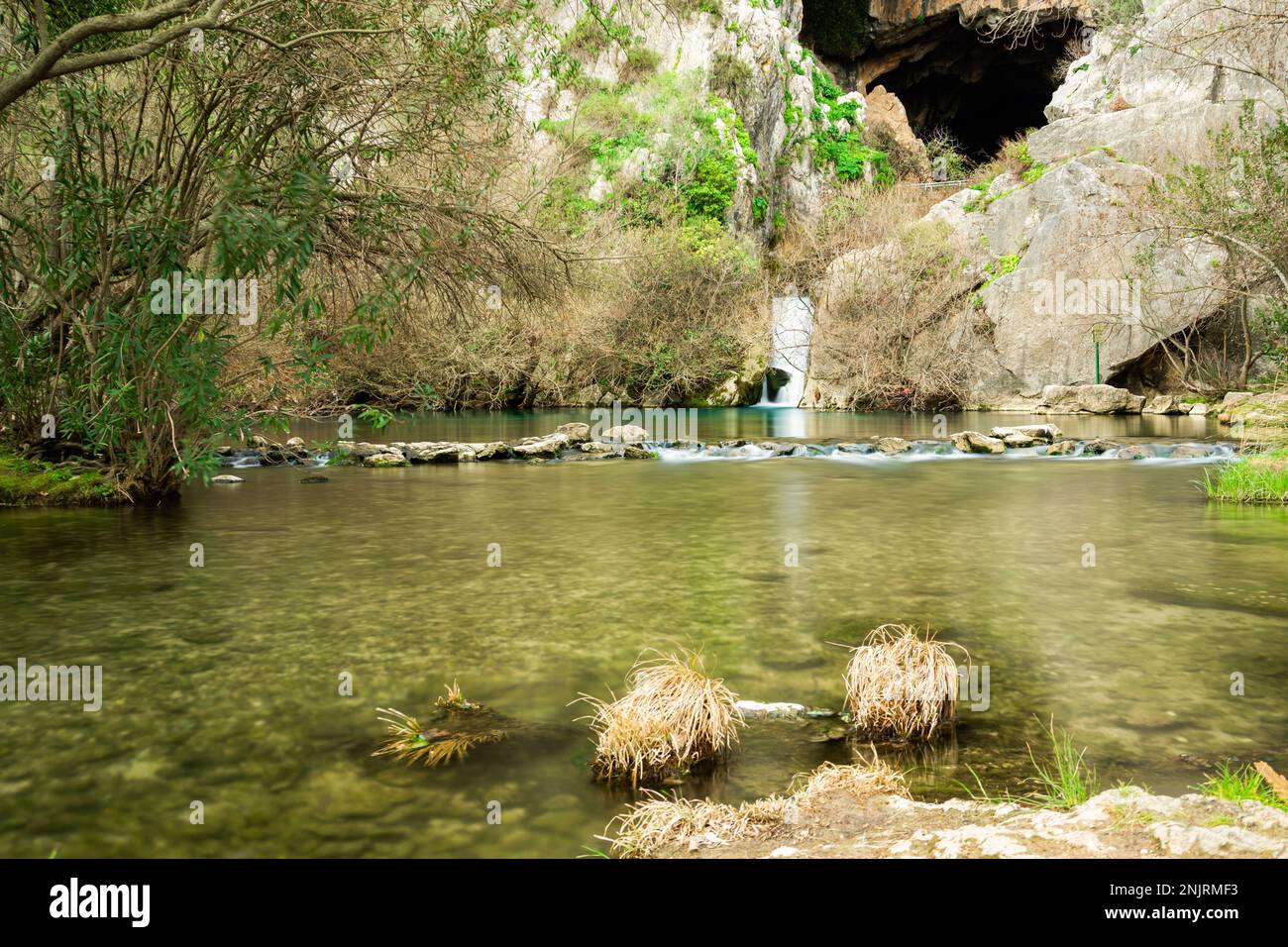 mountain river crystal clear water with waterfall and cave in the ...