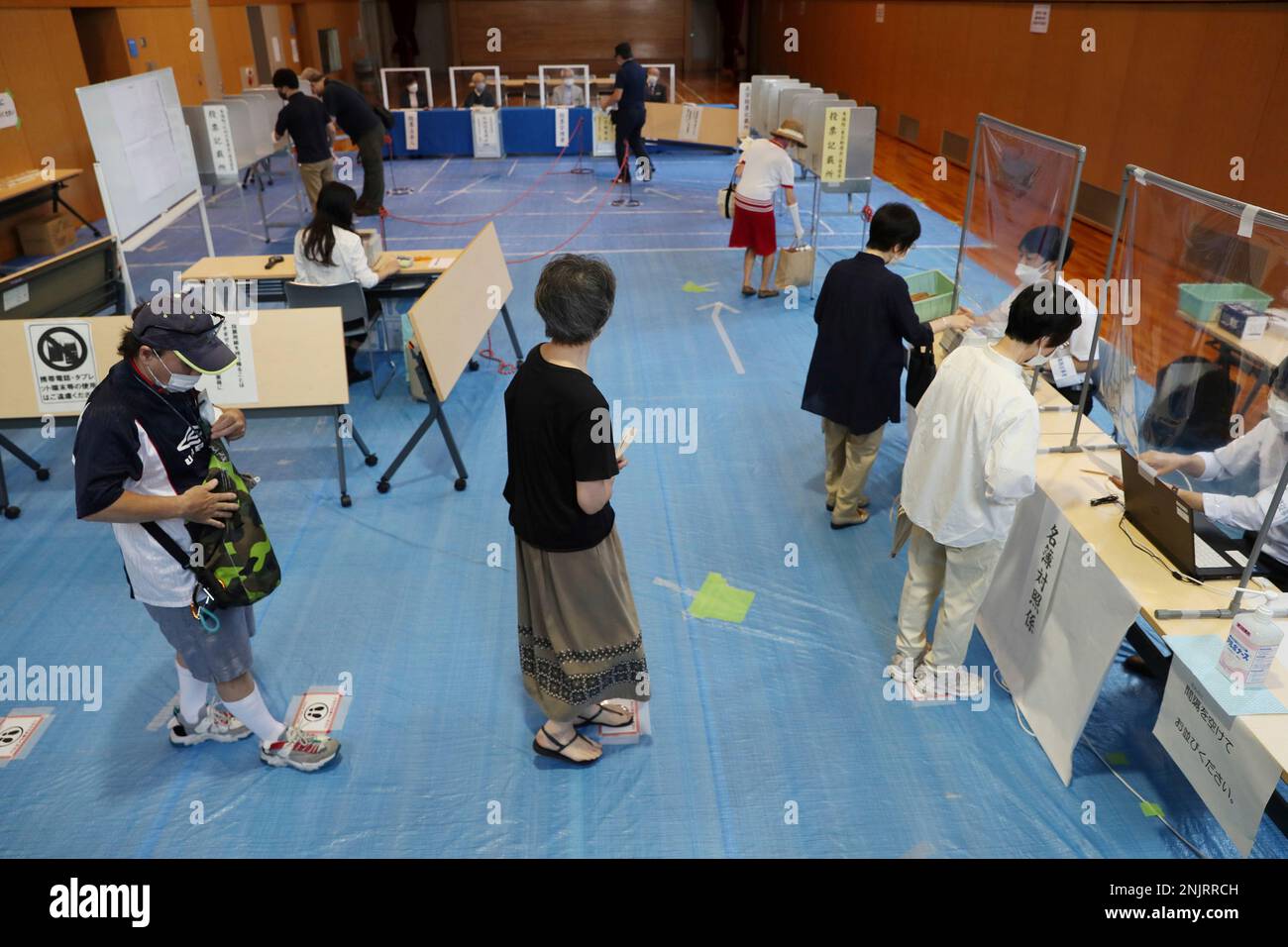 People visit a poll station of the House of Councillors election in