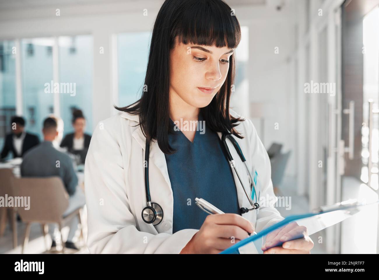 Female doctor writing medical report hi-res stock photography and ...
