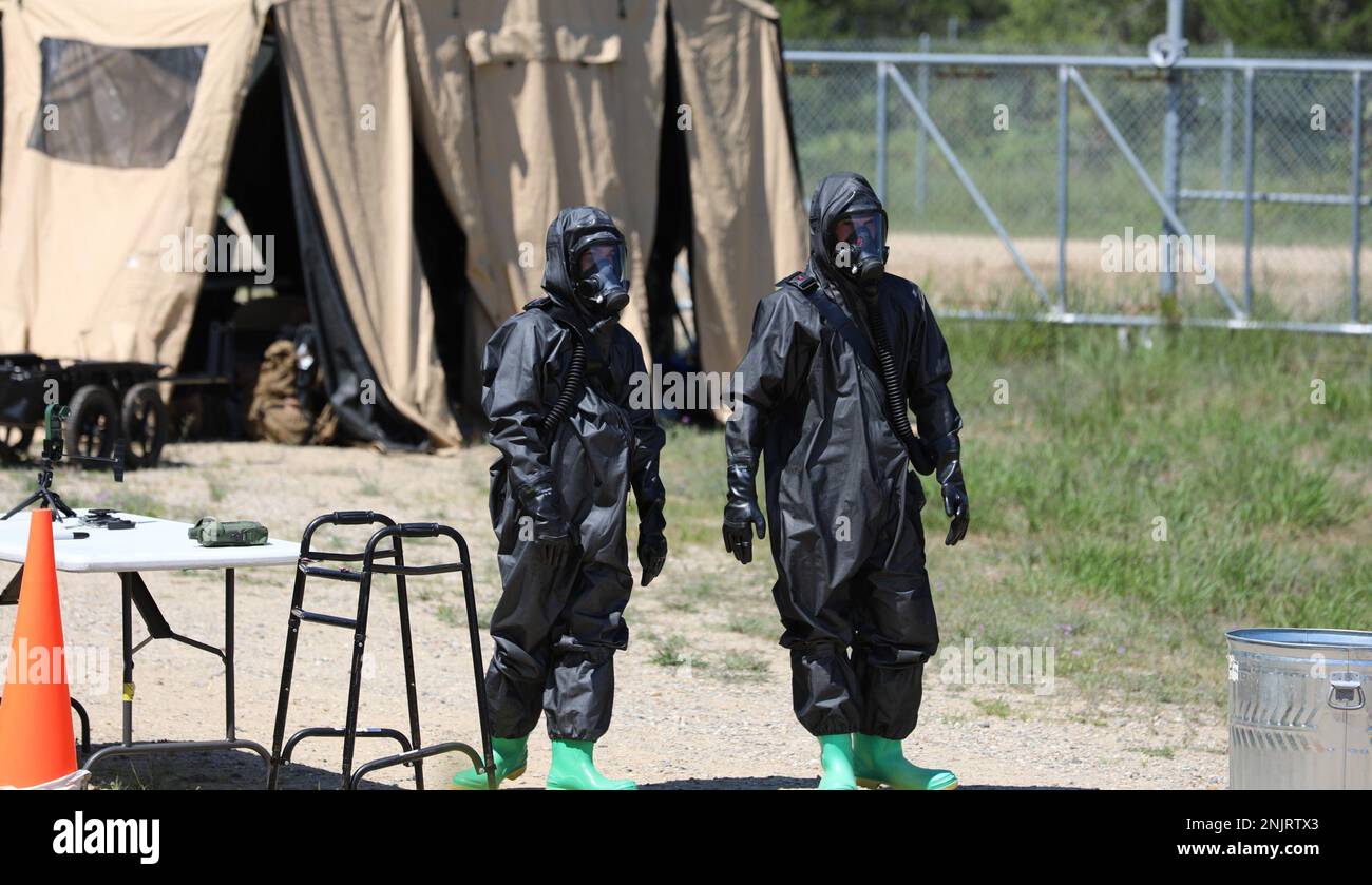 Two Marines from the U.S. Marine Corps, Combat Logistics Regiment 4, Chemical Biological Radiological Nuclear Platoon ready themselves to decontaminate the Search and Recovery team at Northern Strike 22-2 in Grayling, Mich., Aug. 8, 2022. Northern Strike encompasses a collection of unique environments, premier training venues and provides the operational and developmental framework required to fully integrate joint all domain training. Stock Photo