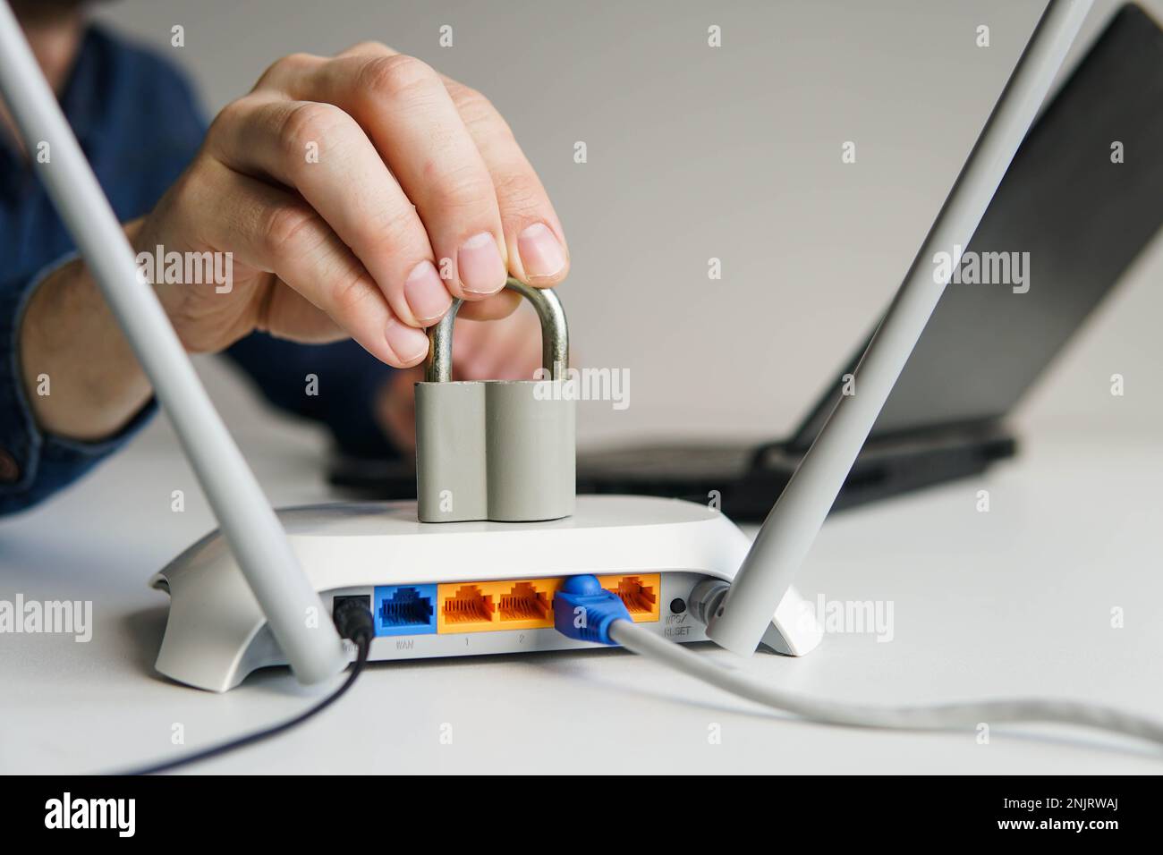 High speed wi-fi router with lock. Man using laptop on the background.  Password protected wifi network and internet censorship concept Stock Photo  - Alamy