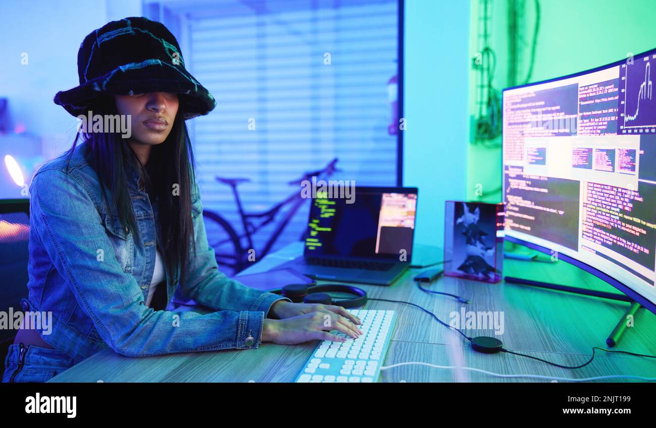 Programming, software and data with a black woman developer working in a neon office for information technology. Computer, cyber security and database Stock Photo