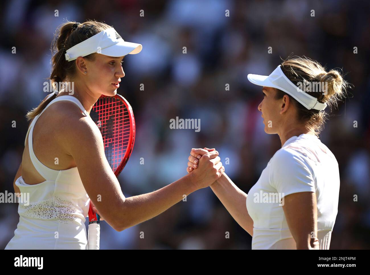 Elena Rybakina (L) of Kazakhstan shakes hands with Simona Halep of Romania after winning the ladies singles semi-finals match in the Championships, Wimbledon at All England Lawn Tennis and Croquet Club in