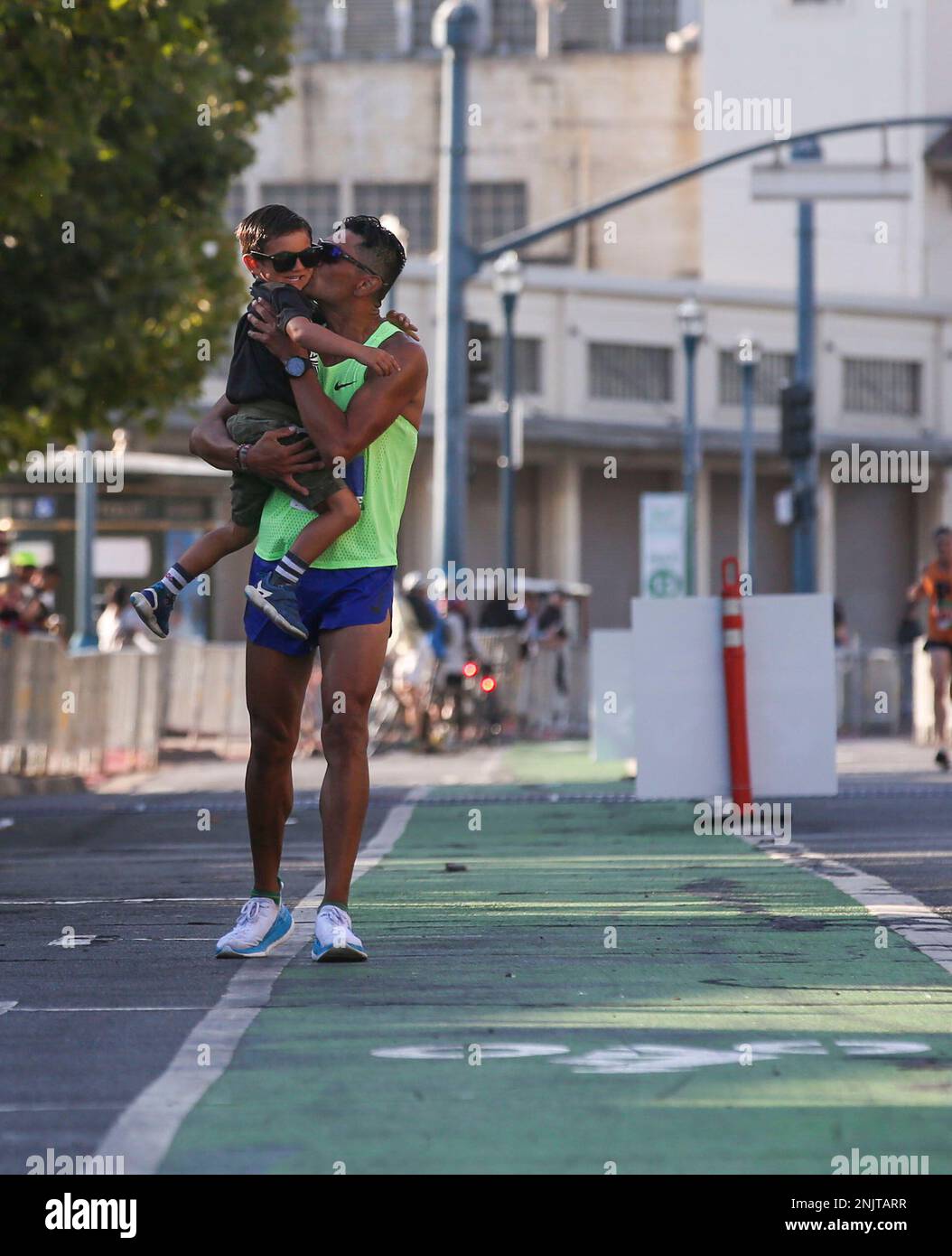 Maravilla kisses his son Joaquin Maravilla as he approaches the