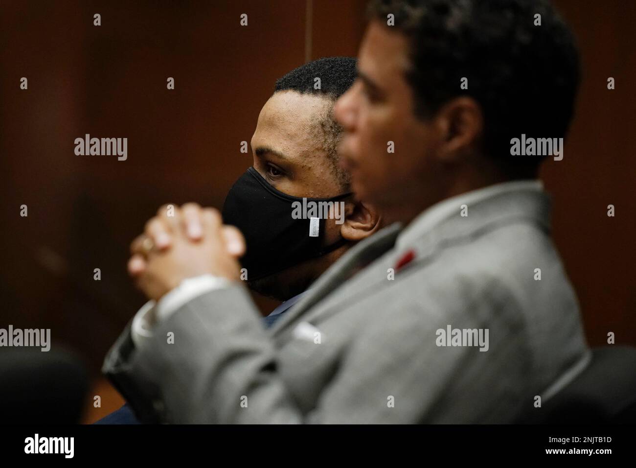 Eric Holder Jr., rear, who is accused of killing rapper Nipsey Hussle