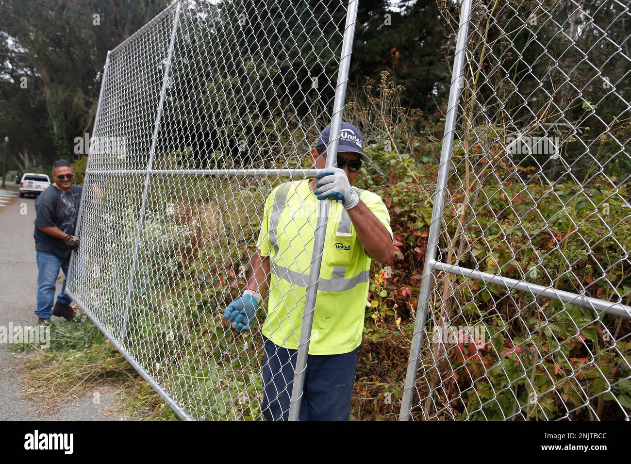 Luis Sul (right), United Site Services fence lead, and Basilio Garcia (left), United Site Services special event service tech, work in Golden Gate Park as they set up fencing for Outside Lands