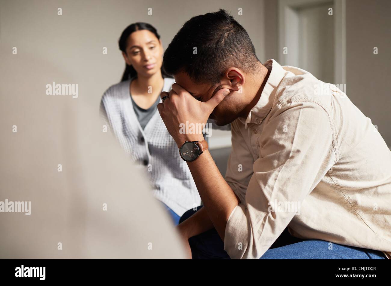 Sad group in therapy and man crying with depression, AA and addiction