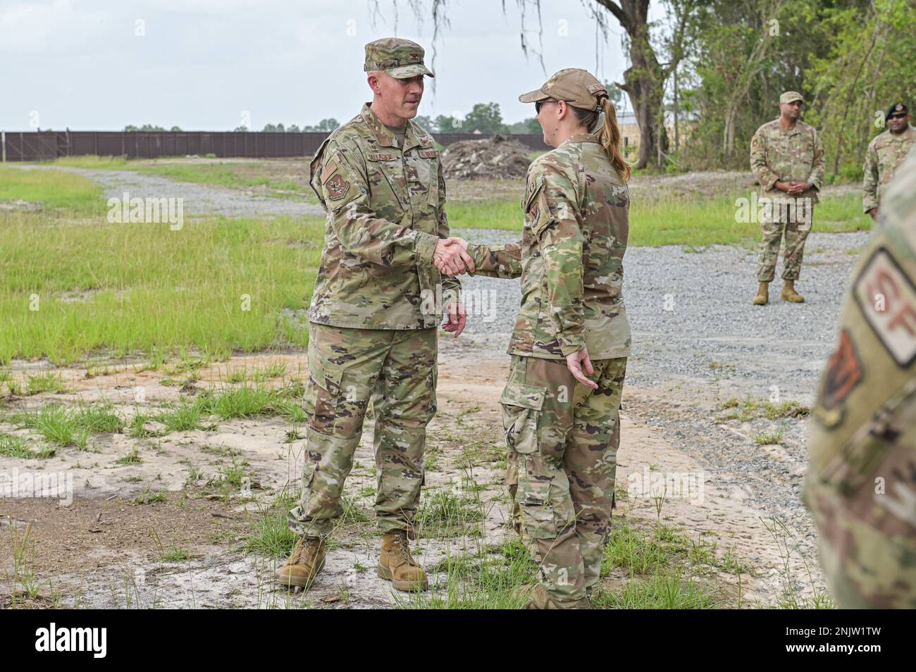 U.S. Air Force Col. Michael Gallagher, 23rd Mission Support Group commander, left, recognizes Staff Sgt. Grace Evenson, 823rd Base Defense Squadron member, for her outstanding service and dedication to the team at Moody Air Force Base, Georgia, Aug. 10, 2022. Evenson was testing new female body armor usability and comfort during routine and tactical maneuvers. Stock Photo