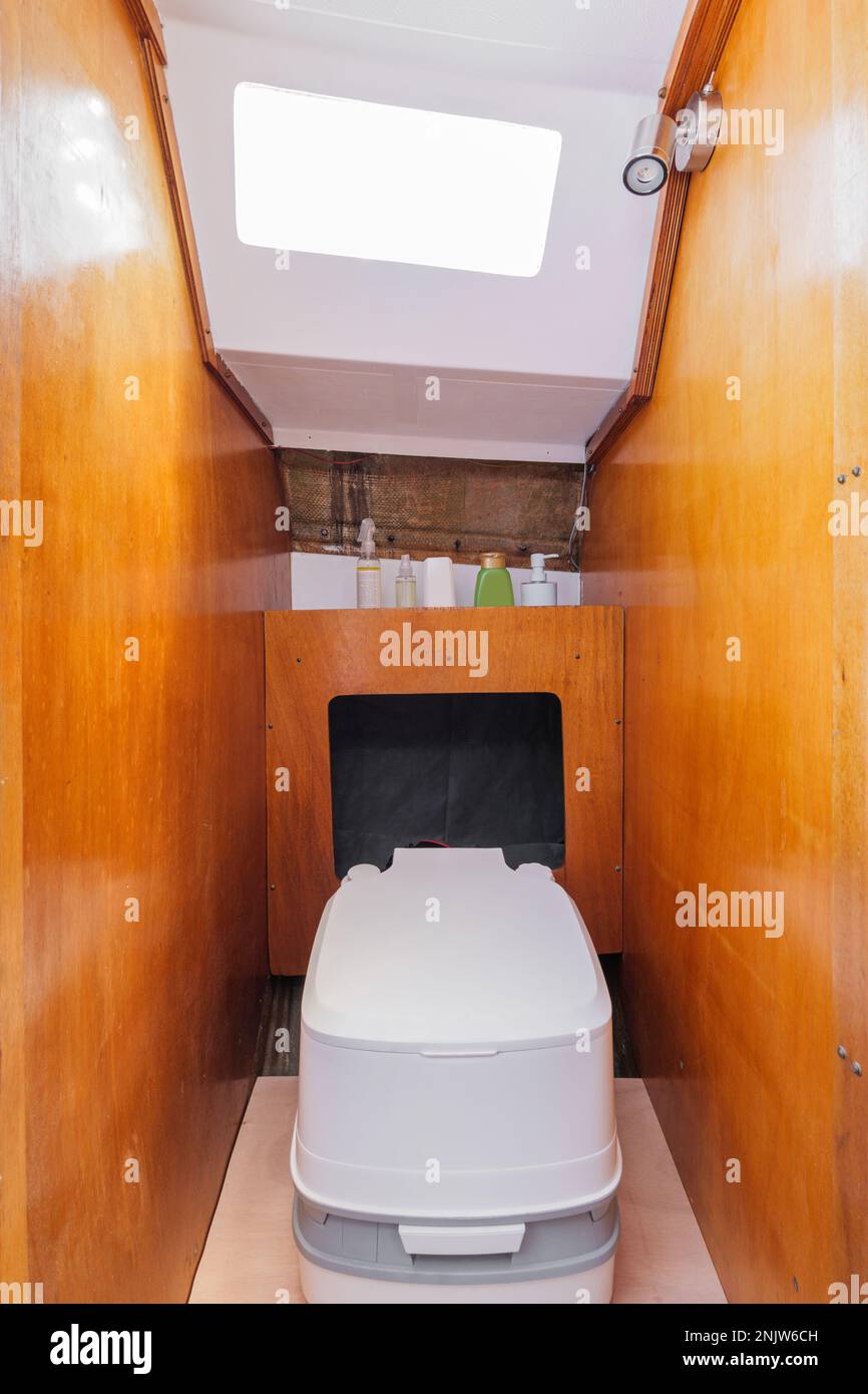 Cozy bathroom in small yacht with wooden walls. Compact stylish modern